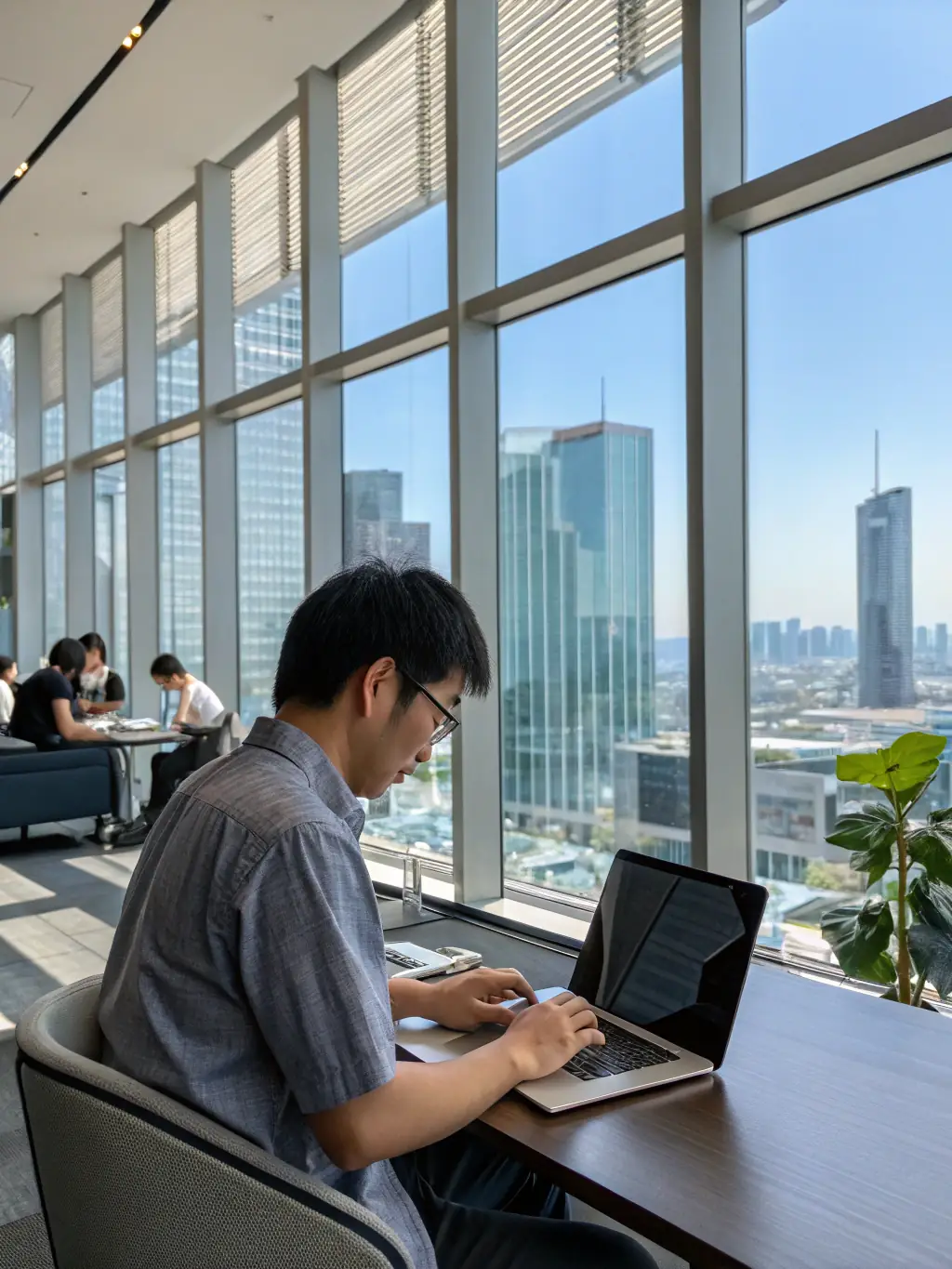 A software engineer in a modern Tokyo office, coding at a computer, reflecting the tech job opportunities Stallion Lanka offers in Japan.
